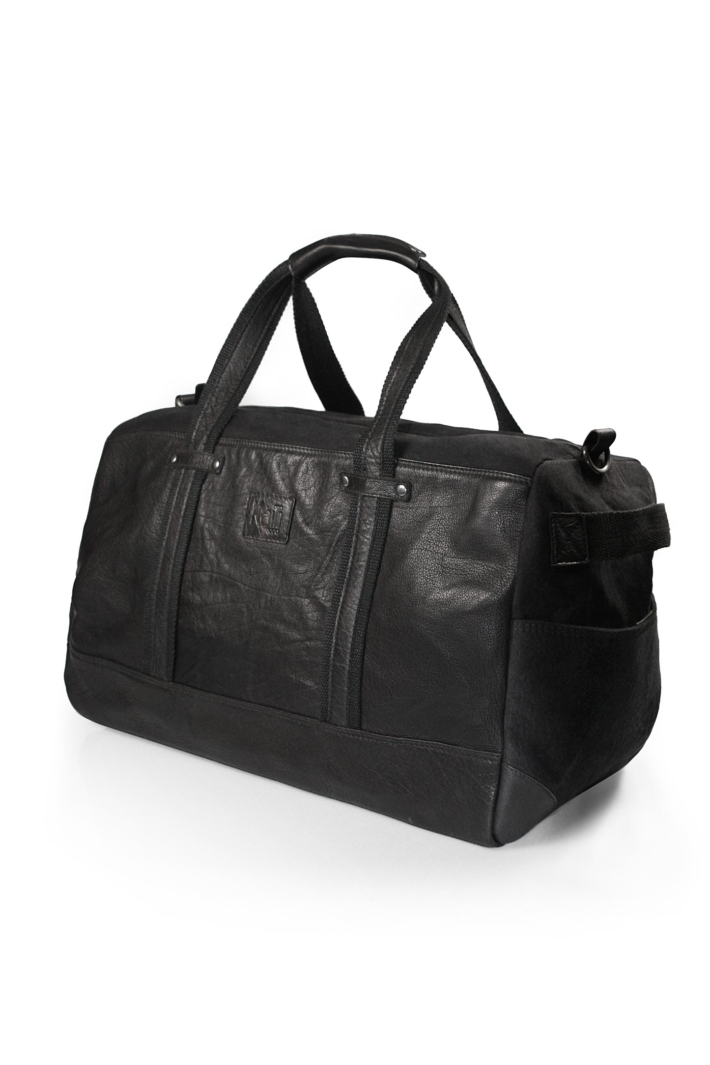 K0024AB | Travel bag in Canvas/Genuine Leather, full grain, flywheel - Black colour. Accessories in antiqued nickel, zip closure. Dimensions: 48 x 31 x 22 cm - Packaging: TNT bag